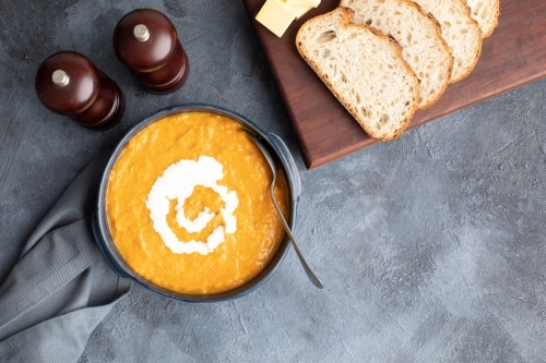top down scene of pumpkin soup and sourdough bread