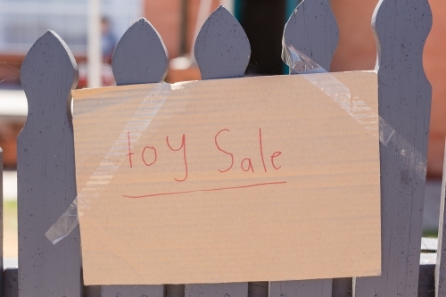 "Toy Sale" cardboard sign on fence