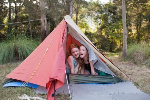 Two girls in an orange tent