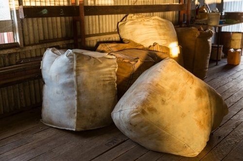 Unpressed merino wool bales in shearing shed