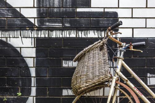 Vintage bike against wall with painted lettering