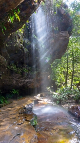 Waterfall and sunbeams over walking track in the Grand Canyon