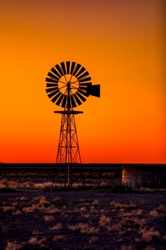 Windmill silhouette against an orange Sunset