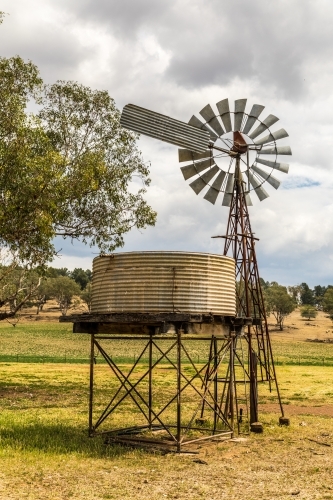 Windpump (windmill) and water tank on a dry farmland property