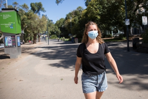 Woman in Face Mask Walking By Yarra River