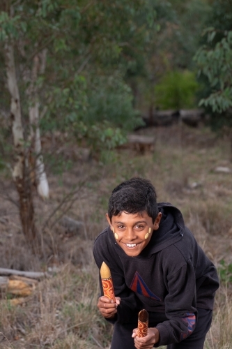 Young Aboriginal Boy with clapstick instrument