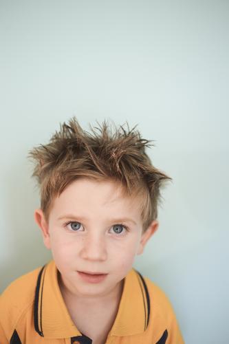 Young boy in school top with spiky hair