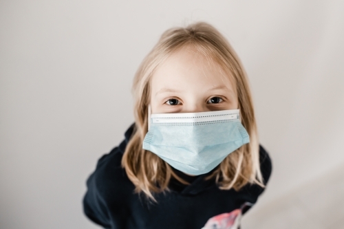Young caucasion girl wearing a mask during the COVID-19 corona virus pandemic