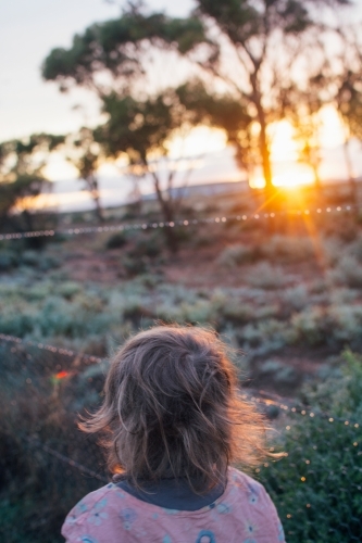 Young girl watching sunrise