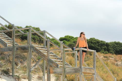 Young woman on wooden steps at the beach