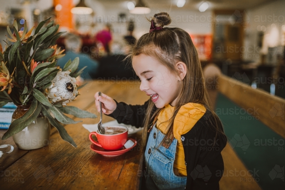 Little Girl drinking a hot chocolate - Australian Stock Image