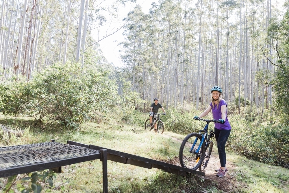 1 female and 1 male biker on a ramp - Australian Stock Image