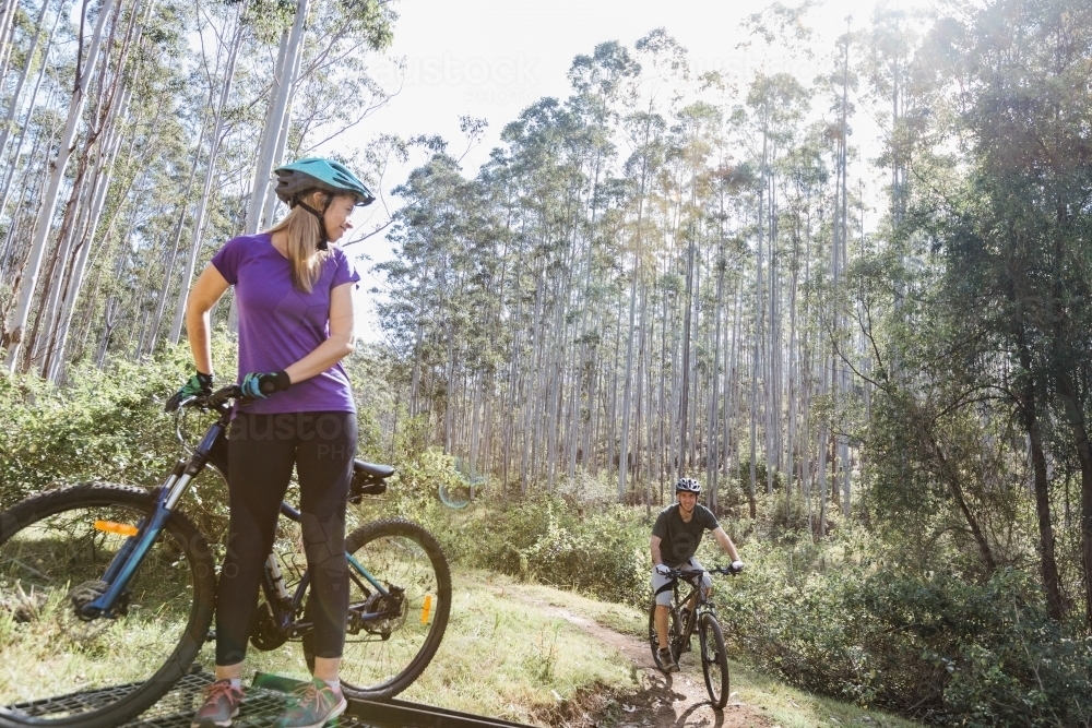 1 female and 1 male cyclist on a hill - Australian Stock Image