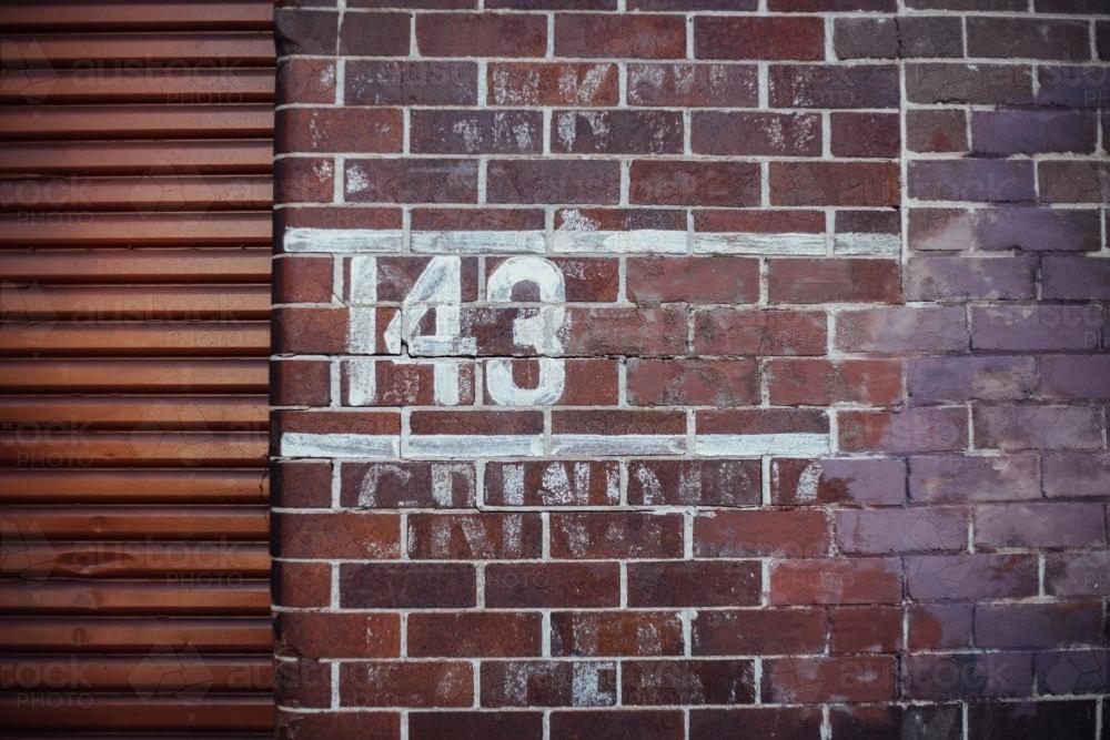 143 painted on brick wall - Australian Stock Image