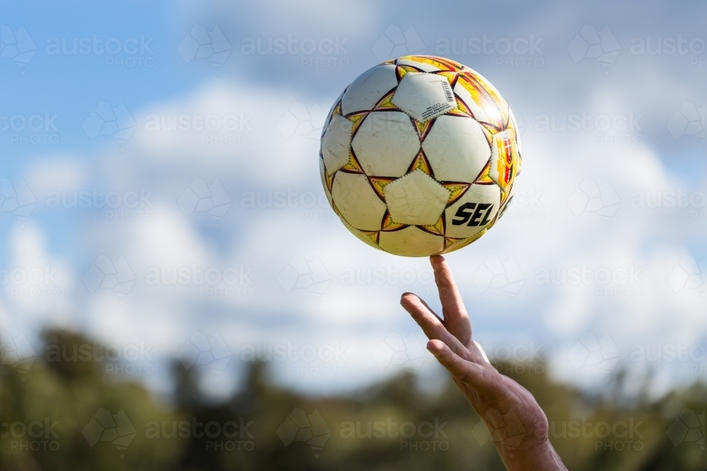 Image of Soccer ball balancing on finger - Austockphoto