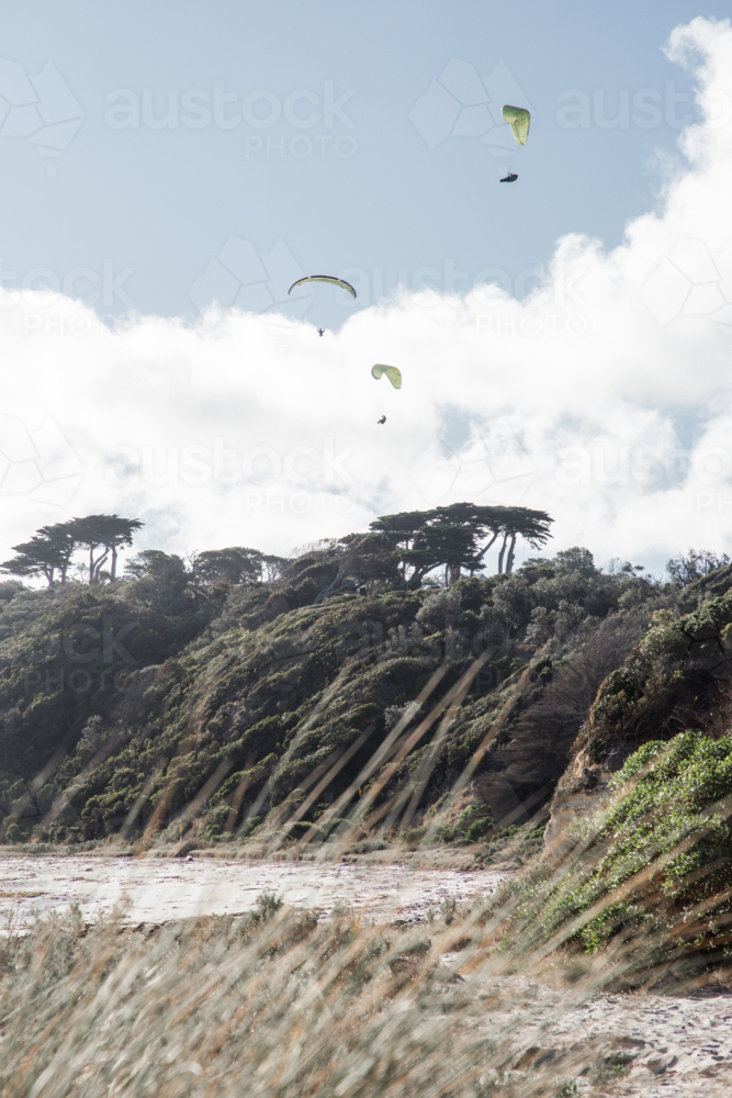 3 Paragliders over the beach - Australian Stock Image