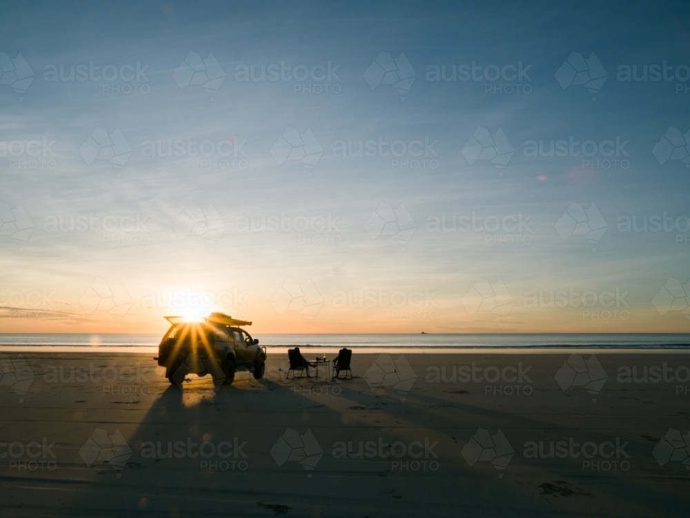 4WD on Cable Beach Next to Two Chairs - Australian Stock Image