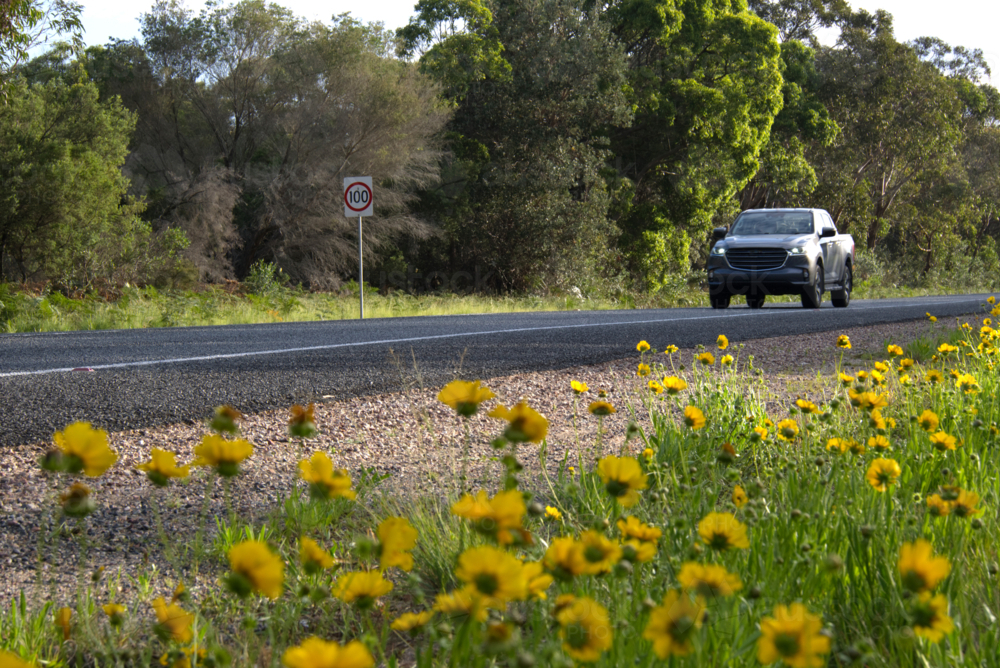 4WD on country road sunny day - Australian Stock Image
