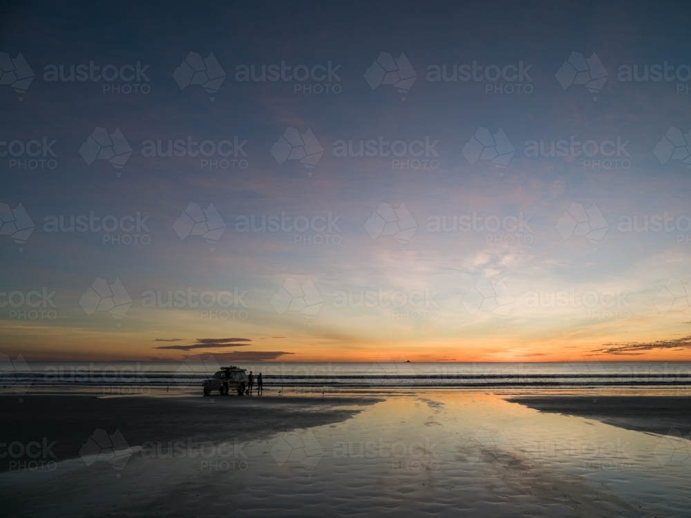 4WD Parked on Cable Beach with Two People - Australian Stock Image