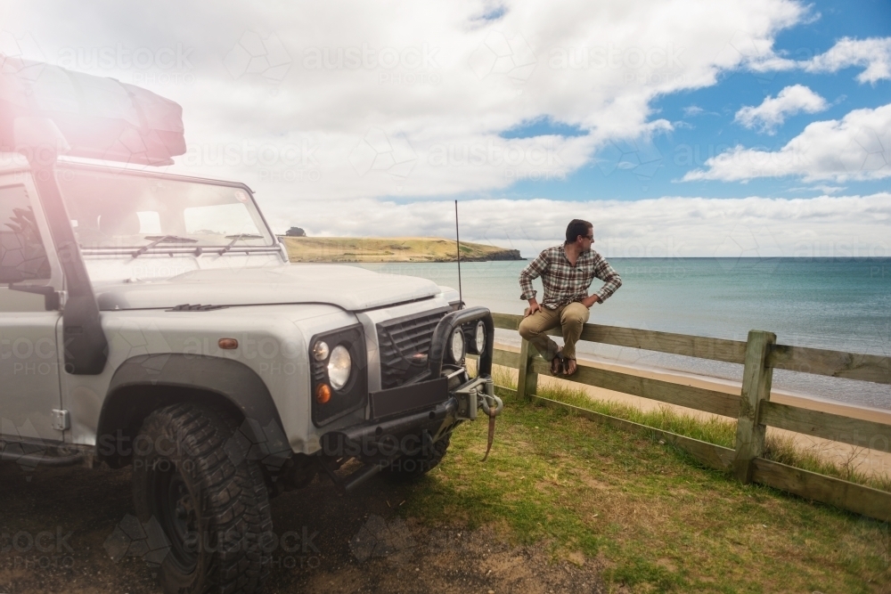 4x4 and man, looking out to ocean - Australian Stock Image