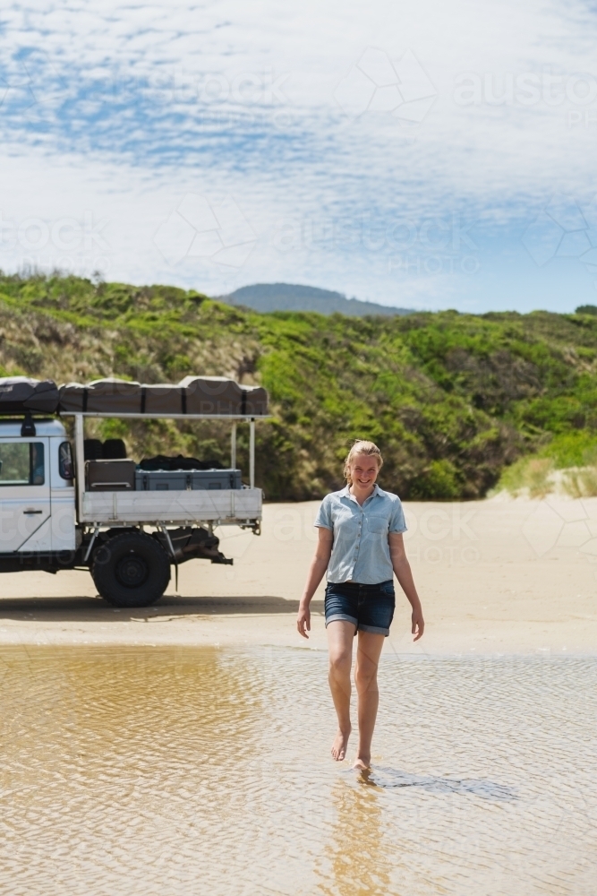 4x4 at the beach, teen girl walking in a creek - Australian Stock Image