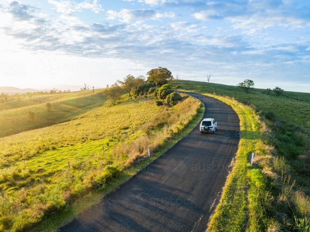 4x4 car driving on country road trip adventure on narrow road at sunset - Australian Stock Image