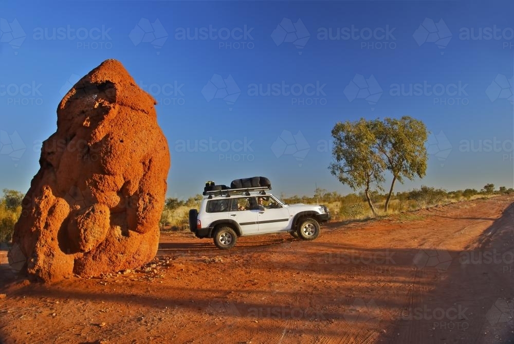 4x4 car next to a very large anthill, or termite mound, NT - Australian Stock Image