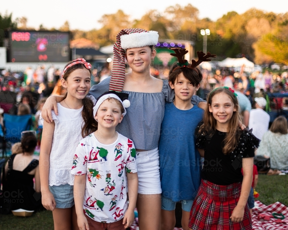 5 happy kids at community Christmas carols together - Australian Stock Image