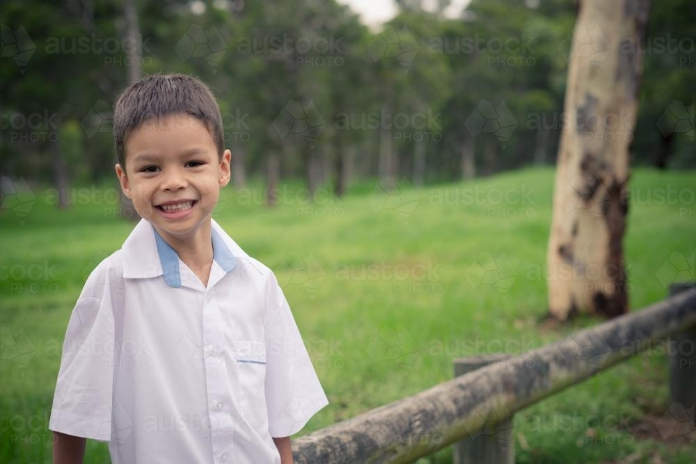 5 year old mixed race boy wearing his school uniform on his first day of school - Australian Stock Image