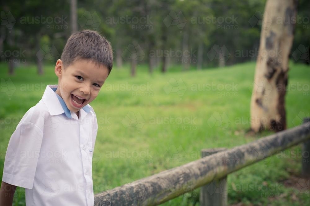 5 year old mixed race boy wearing his school uniform on his first day of school - Australian Stock Image