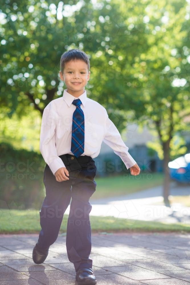 5 year old mixed race boy wearing his school uniform on his first day of school - Australian Stock Image