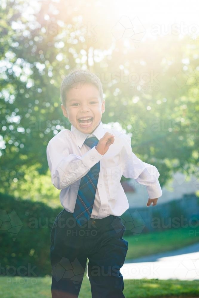 5 year old mixed race boy wearing his school uniform on his first day of school - Australian Stock Image