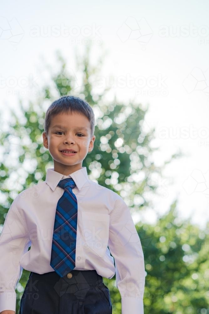 5 year old mixed race boy wearing his school uniform on his first day of school - Australian Stock Image