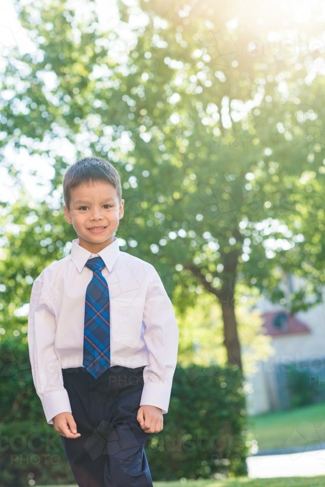 5 year old mixed race boy wearing his school uniform on his first day of school - Australian Stock Image