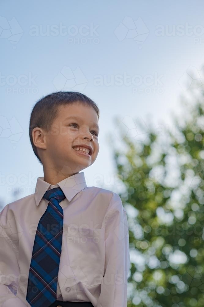 5 year old mixed race boy wearing his school uniform on his first day of school - Australian Stock Image
