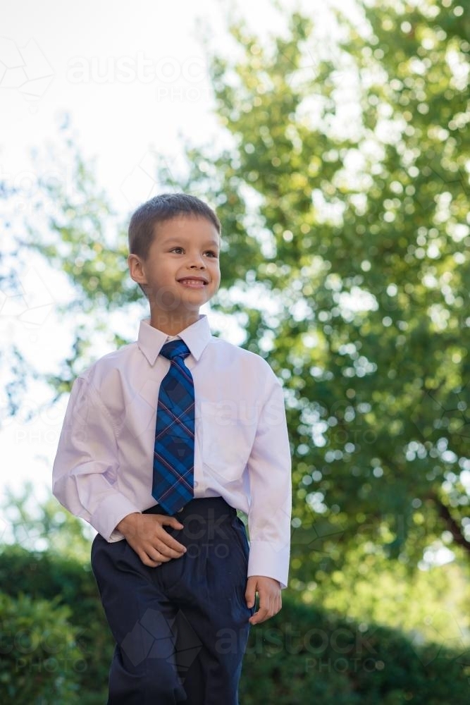 5 year old mixed race boy wearing his school uniform on his first day of school - Australian Stock Image