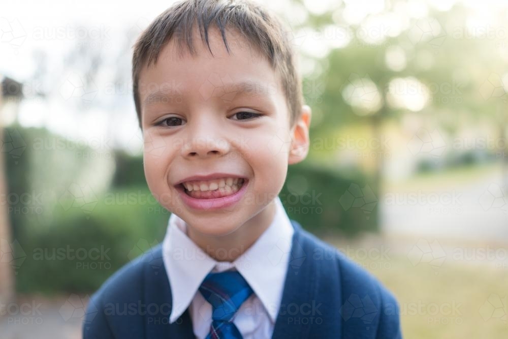 5 year old mixed race boy wearing his winter school uniform - Australian Stock Image
