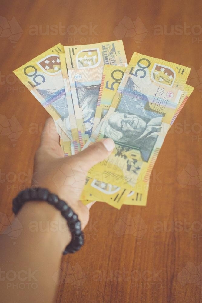 50 dollar notes in hand - Australian Stock Image
