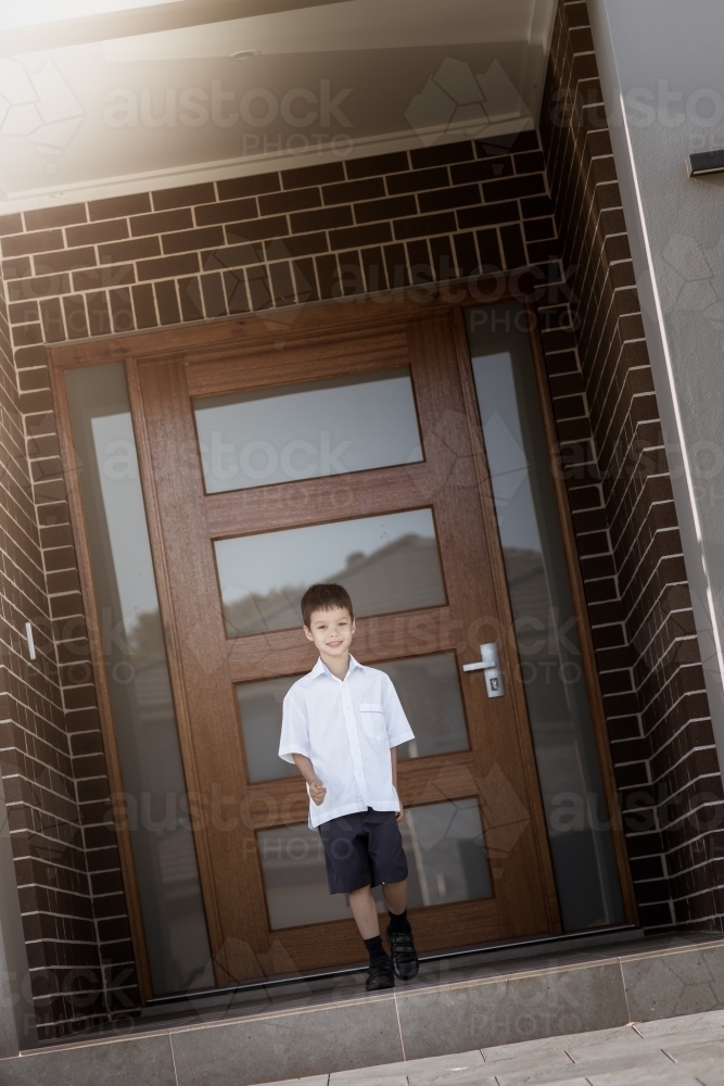 6 year old mixed race boy leaves home for his first day of school - Australian Stock Image