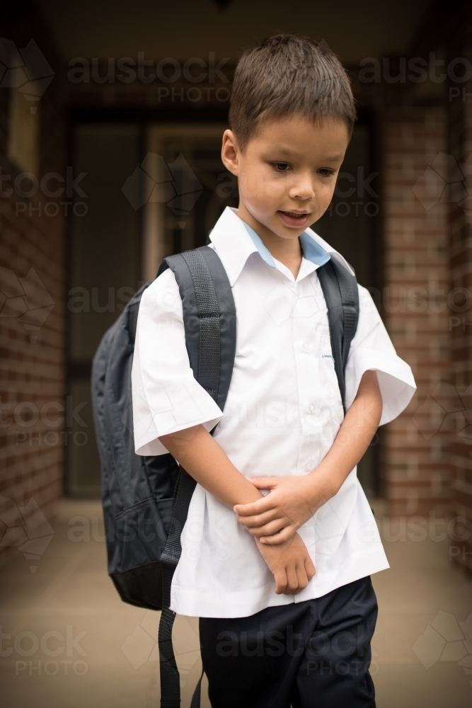 6 year old mixed race boy leaves home for his first day of school - Australian Stock Image