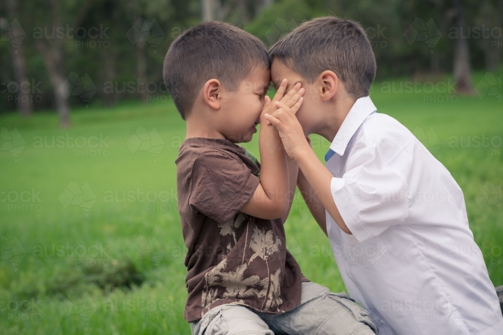 6 year old mixed race boy plays with his brother before leaving on his first day of school - Australian Stock Image