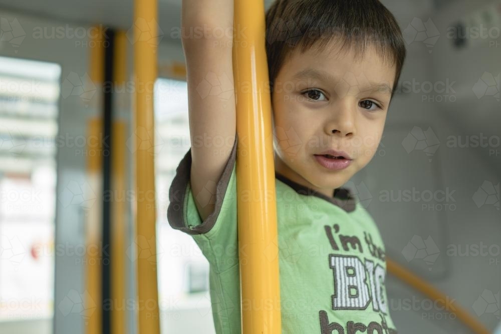 6 year old mixed race boy rides on a Sydney city train - Australian Stock Image