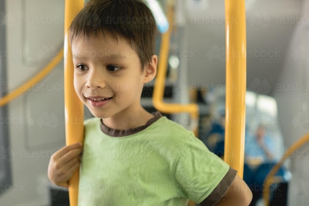 6 year old mixed race boy rides on a Sydney city train - Australian Stock Image