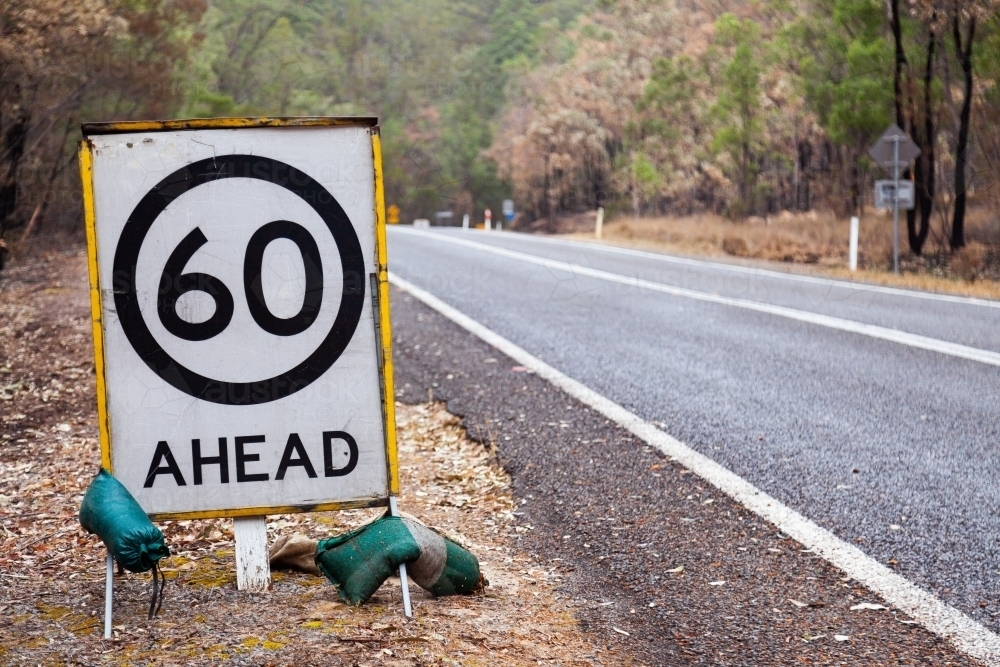 60 road speed sign in area burnt by bushfire - Australian Stock Image