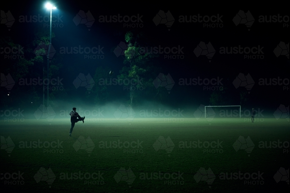 Game in play on football field in fog - Australian Stock Image