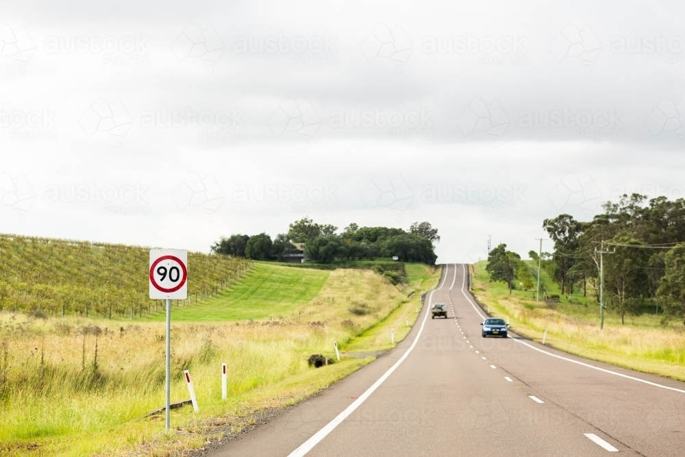 90 speed sign on road beside vineyards in Hunter Valley - Australian Stock Image