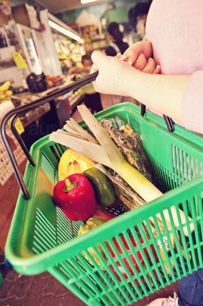 a basketful of fruit and veg at a greengrocer - Australian Stock Image