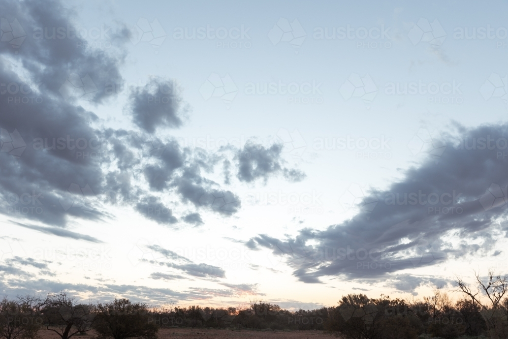 A big sky with scattered clouds above outback landscape - Australian Stock Image