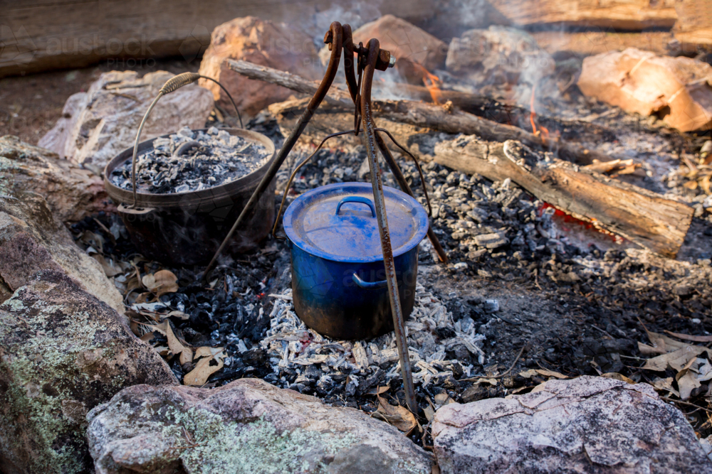A bill can and a camp oven at a campfire - Australian Stock Image