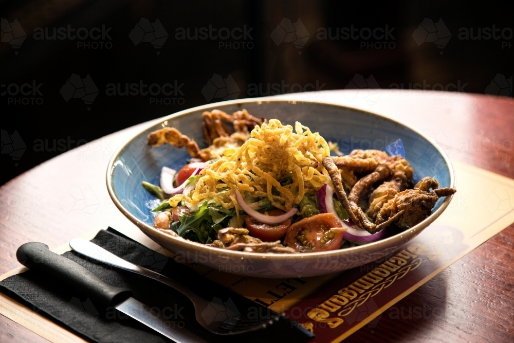 A bowl of soft shell crab salad at restaurant - Australian Stock Image